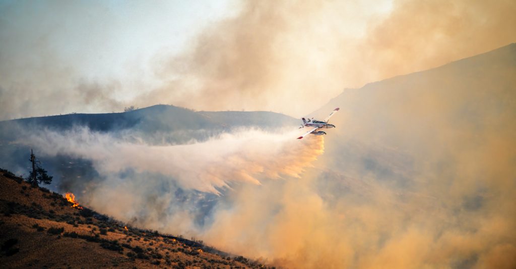 Photo by Frank Cone: https://www.pexels.com/photo/airplane-flying-over-burning-hilly-terrain-and-spreading-extinguishing-powder-9835606/