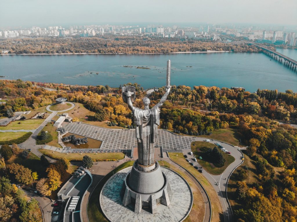 Photo by Petkevich Evgeniy: https://www.pexels.com/photo/aerial-view-of-motherland-monument-and-daniparo-river-in-kyiv-9955097/