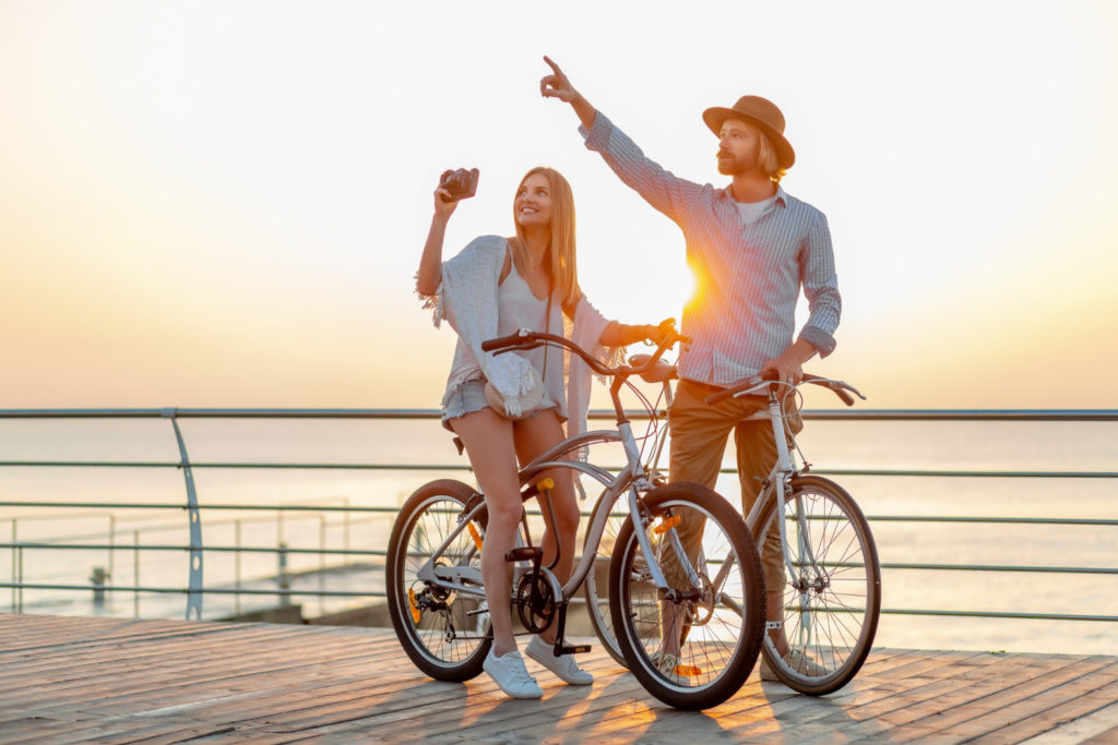 attractive-happy-couple-traveling-summer-bicycles-man-woman-with-blond-hair-boho-hipster-style-fashion-having-fun-together-taking-photos-sightseeing