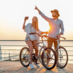 attractive-happy-couple-traveling-summer-bicycles-man-woman-with-blond-hair-boho-hipster-style-fashion-having-fun-together-taking-photos-sightseeing