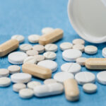 Medicament pills on medical blue background