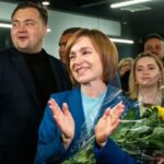 the-incumbent-president-of-moldova-maia-sandu-flanked-by-her-supporters-following-the-announcement-of-the-preliminary-election-results-at-her-campaign-headquarters-in-chisinau-moldova-696x366