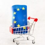 close-up-flag-shopping-cart-against-white-background_1048944-17026994